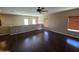 Spacious loft featuring wood floors, ample natural light, and a ceiling fan, perfect for relaxation at 44328 W Knauss Dr, Maricopa, AZ 85138