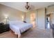 Spacious main bedroom with a ceiling fan and an ensuite bathroom at 44328 W Knauss Dr, Maricopa, AZ 85138
