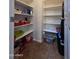 Organized pantry with shelving provides ample storage space for groceries and household items at 44328 W Knauss Dr, Maricopa, AZ 85138