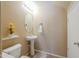 Well-lit powder room featuring a pedestal sink and neutral wall color at 44328 W Knauss Dr, Maricopa, AZ 85138