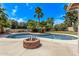 Backyard oasis with a pool, fire pit and lush landscaping at 4442 E Redfield Rd, Phoenix, AZ 85032