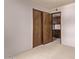 Bedroom featuring neutral carpeting, a ceiling fan, and wood doors to the attached closet at 4442 E Redfield Rd, Phoenix, AZ 85032