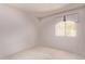 Bright bedroom with neutral carpeting, white walls, and a window offering natural light at 4442 E Redfield Rd, Phoenix, AZ 85032
