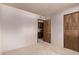 Bedroom featuring neutral walls, carpet and wood doors to the attached closet at 4442 E Redfield Rd, Phoenix, AZ 85032