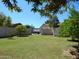 Long driveway leading to the home, framed by mature trees and greenery, creating a welcoming approach at 4442 E Redfield Rd, Phoenix, AZ 85032