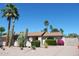 Charming exterior elevation of a single-story home with desert landscaping, and mature palm and Saguaro cactus at 4442 E Redfield Rd, Phoenix, AZ 85032