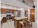 This kitchen has stainless steel appliances, a center island with bar seating, and neutral countertops at 4442 E Redfield Rd, Phoenix, AZ 85032