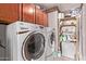 Well-equipped laundry room featuring modern washer, dryer, and storage shelves for added convenience at 4442 E Redfield Rd, Phoenix, AZ 85032