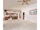 Open living space with a kitchen bar, a large window, plush carpet and access to appliances at 4442 E Redfield Rd, Phoenix, AZ 85032