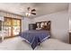 A relaxing main bedroom featuring a ceiling fan and private access to the outdoor patio at 4442 E Redfield Rd, Phoenix, AZ 85032