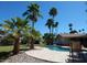 Backyard pool and patio area with a lush tropical landscaping and pavers at 4442 E Redfield Rd, Phoenix, AZ 85032