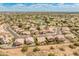 Expansive aerial view of a residential neighborhood with pools, golf course, and surrounding desert landscape at 5936 W Via Montoya Dr, Glendale, AZ 85310