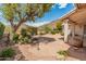 Private backyard with stone patio, small waterfall feature, lush landscaping, and mountain views at 5936 W Via Montoya Dr, Glendale, AZ 85310