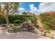 Beautiful pond in a landscaped backyard with mature trees and mountain views at 5936 W Via Montoya Dr, Glendale, AZ 85310