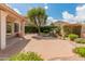 Charming backyard showcasing a serene rock waterfall feature surrounded by vibrant greenery and stone patio at 5936 W Via Montoya Dr, Glendale, AZ 85310