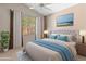 Beautiful bedroom with vaulted ceiling, fan, and beach artwork above the bed at 5936 W Via Montoya Dr, Glendale, AZ 85310