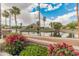 Scenic community lake featuring palm trees, lush landscaping, and picturesque mountain backdrop at 5936 W Via Montoya Dr, Glendale, AZ 85310