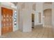 Inviting entryway featuring tile flooring, a decorative front door, and access to various rooms at 5936 W Via Montoya Dr, Glendale, AZ 85310