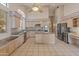 Bright kitchen features stainless steel appliances, an island, and large windows that provide lots of natural light at 5936 W Via Montoya Dr, Glendale, AZ 85310