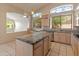 Spacious kitchen featuring a center island, granite countertops, and ample cabinet space at 5936 W Via Montoya Dr, Glendale, AZ 85310