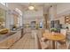 Bright kitchen featuring granite countertops, light wood cabinets, an island, and stainless steel appliances at 5936 W Via Montoya Dr, Glendale, AZ 85310