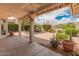 Covered patio area overlooking a professionally landscaped yard at 5936 W Via Montoya Dr, Glendale, AZ 85310