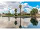 Beautiful pond reflecting trees, sky, and mountain in the distance at 5936 W Via Montoya Dr, Glendale, AZ 85310
