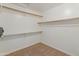 Empty walk-in closet with beige carpet and white walls, ready to be stocked with your wardrobe at 5936 W Via Montoya Dr, Glendale, AZ 85310
