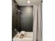 Modern bathroom with a shower-tub combo, dark tile walls, and a gray shower curtain for a sleek look at 7157 E Rancho Vista Dr # 2005, Scottsdale, AZ 85251
