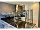 Contemporary kitchen with a black countertop, stainless steel appliances, and modern fixtures at 7157 E Rancho Vista Dr # 2005, Scottsdale, AZ 85251