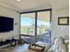 Bright living room boasting floor-to-ceiling windows with views, sleek furniture, and hardwood floors at 7157 E Rancho Vista Dr # 2005, Scottsdale, AZ 85251