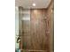 Sleek shower stall with stylish wood-look tile, a modern showerhead, and glass doors for a spa-like experience at 7157 E Rancho Vista Dr # 2005, Scottsdale, AZ 85251