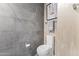 Contemporary bathroom with sleek toilet, tiled wall, and stylish towel rack at 7180 E Kierland Blvd # 1218, Scottsdale, AZ 85254