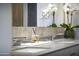Close-up of bathroom vanity with quartz countertop, double sink, and decorative flower arrangement at 7180 E Kierland Blvd # 1218, Scottsdale, AZ 85254