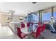 Elegant dining area with a glass table, red chairs, and city views through expansive windows, creating a luxurious atmosphere at 7180 E Kierland Blvd # 1218, Scottsdale, AZ 85254