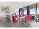 Open-concept dining room with a glass table, red chairs, and large windows showcasing city views at 7180 E Kierland Blvd # 1218, Scottsdale, AZ 85254