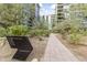Beautifully landscaped walkway in a modern building complex, featuring verdant trees and manicured shrubs at 7180 E Kierland Blvd # 1218, Scottsdale, AZ 85254