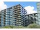 Modern building exterior with lush landscaping, balconies, and floor-to-ceiling windows at 7180 E Kierland Blvd # 1218, Scottsdale, AZ 85254