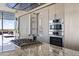 Modern kitchen boasts stainless steel appliances, granite countertops, and sleek cabinetry with a view at 7180 E Kierland Blvd # 1218, Scottsdale, AZ 85254
