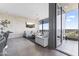 Stylish living room with modern decor, a large window, and access to a balcony at 7180 E Kierland Blvd # 1218, Scottsdale, AZ 85254