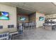 Elegant outdoor kitchen and seating area with stainless steel appliances and flat-screen TVs for entertaining at 7180 E Kierland Blvd # 1218, Scottsdale, AZ 85254