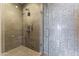 Modern walk-in shower with glass door and unique tile, offering a luxurious bathing experience at 7180 E Kierland Blvd # 1218, Scottsdale, AZ 85254
