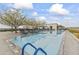 Beautifully designed swimming pool with blue ladder and pristine water set against a backdrop of trees at 7180 E Kierland Blvd # 1218, Scottsdale, AZ 85254