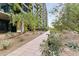 Tranquil walkway lined with greenery and stone leads to a contemporary building covered in climbing vegetation at 7180 E Kierland Blvd # 1218, Scottsdale, AZ 85254