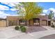 Charming home with stone accents, lush landscaping, and inviting front porch at 7726 E Kimsey Ln, Scottsdale, AZ 85257