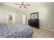 Bedroom featuring wood laminate flooring, ceiling fan and a dark dresser at 8331 E Plata Ave, Mesa, AZ 85212