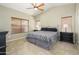 Bedroom featuring wood laminate flooring, ceiling fan and a dark metal bed frame at 8331 E Plata Ave, Mesa, AZ 85212