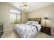 Comfortable bedroom featuring wood laminate flooring, ceiling fan and a wooden bed frame at 8331 E Plata Ave, Mesa, AZ 85212