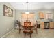 Cozy dining area with wood table, four chairs, and natural lighting creating a warm and inviting atmosphere at 8331 E Plata Ave, Mesa, AZ 85212