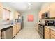 Well-lit kitchen features stainless steel appliances and light wood cabinets, offering ample storage and workspace at 8331 E Plata Ave, Mesa, AZ 85212